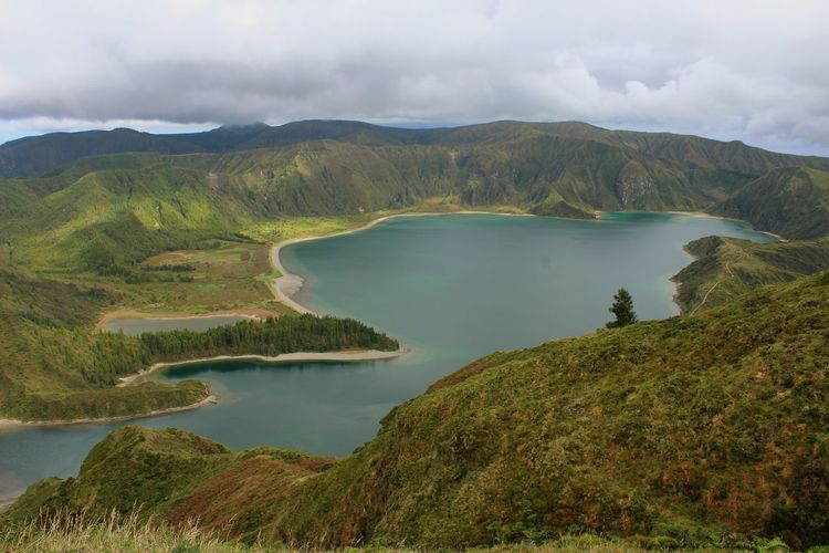 Scenic view of lake and mountains against sky