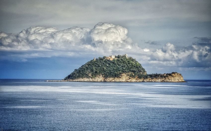 Scenic view of sea and island against sky