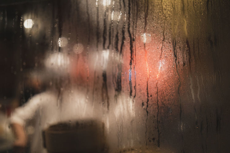 Close-up of condensation on restaurant window at night