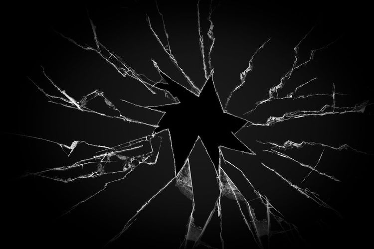 Low angle view of spider web against black background