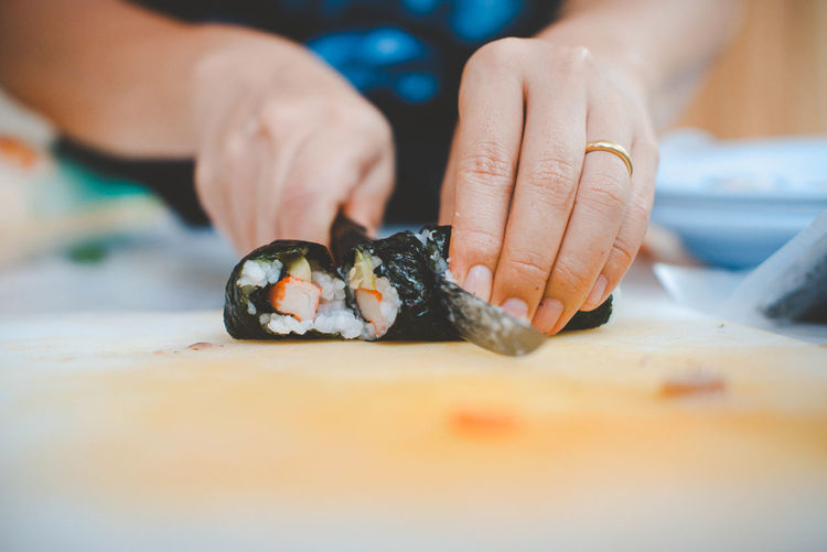 Cropped hand of woman holding food