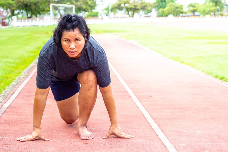 Portrait of mature woman on sports track