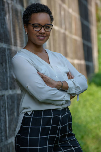 A young pretty african american businesswoman in a park with summer temperatures.