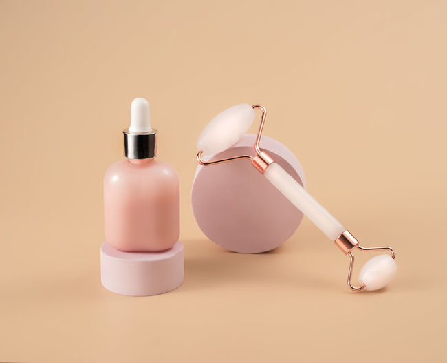 Rose quartz massage roller, sleeping mask and bottle of cosmetic oil