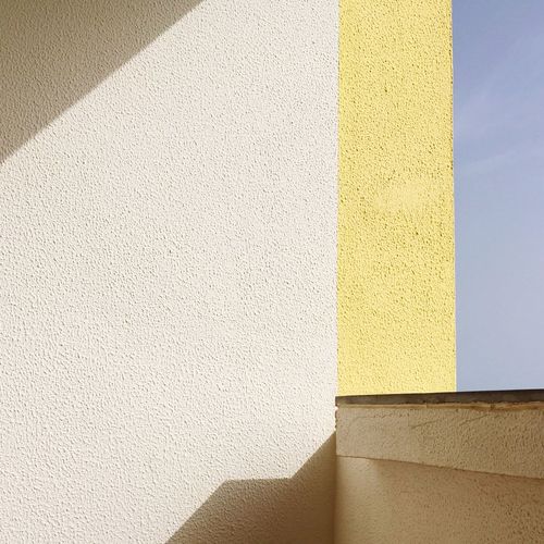 Close-up of yellow shadow on wall
