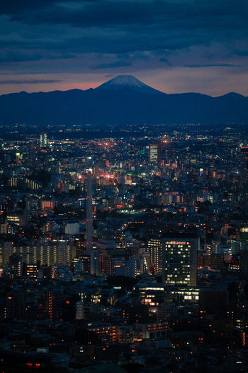High angle view of night time tokyo with mt fuji in the background