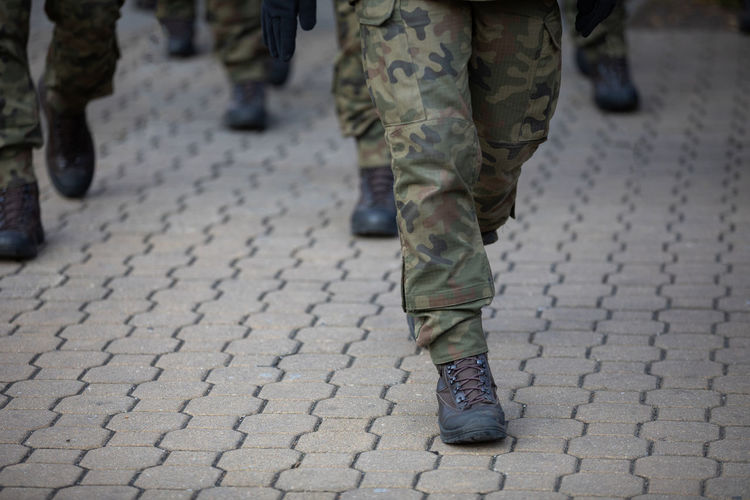 Low section of soldiers walking on street