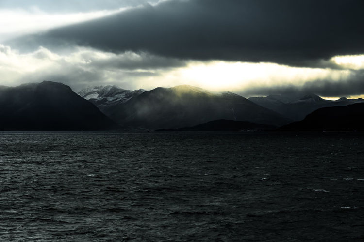 Scenic view of mountains against cloudy sky