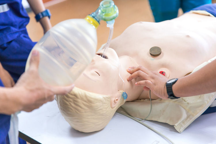 Paramedics practicing with dummy at hospital