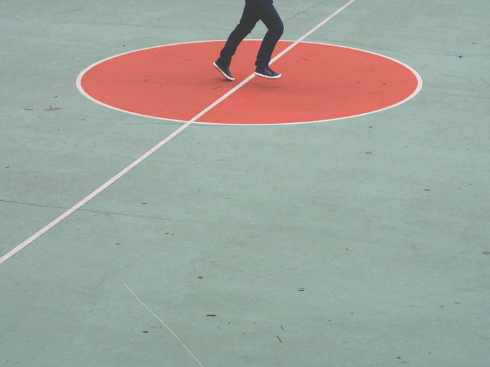 Low section of person running on court