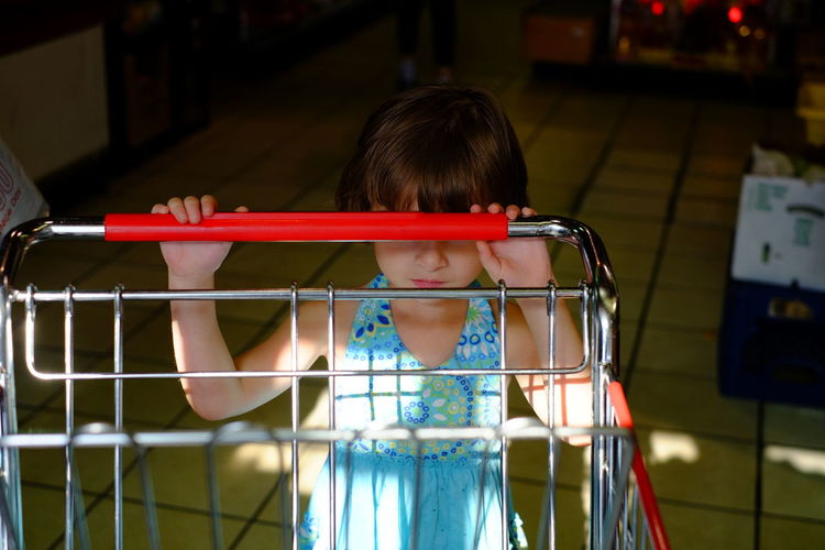 Child pushing shopping cart
