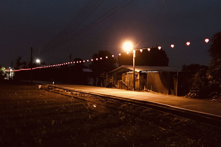 View of illuminated railroad tracks at night