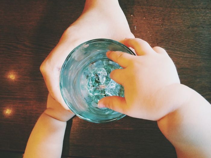 Close-up of cropped hand holding water