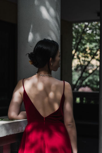 Rear view of woman standing at home