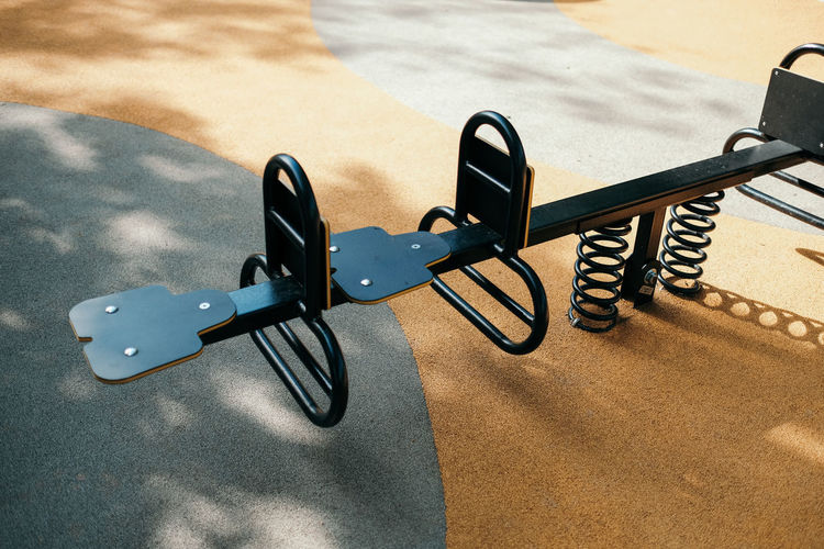 High angle view of steel seesaw at children playground