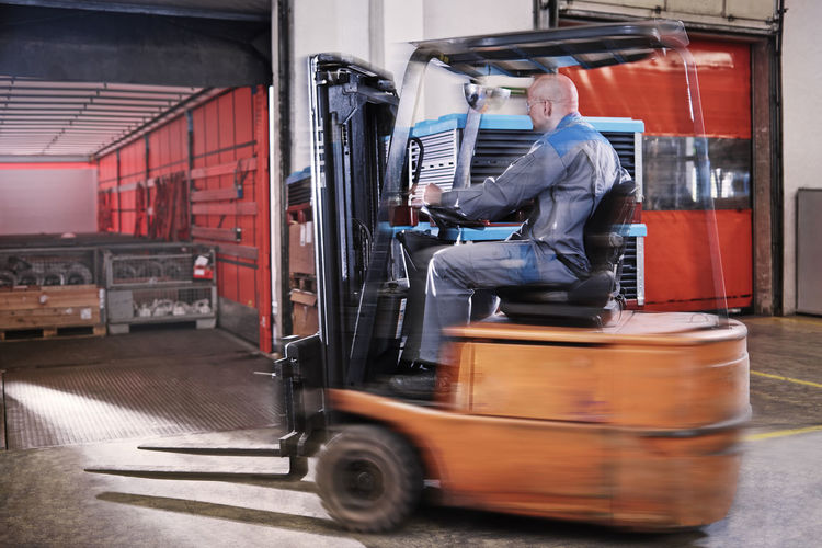 Fork-lift driver loading lorry