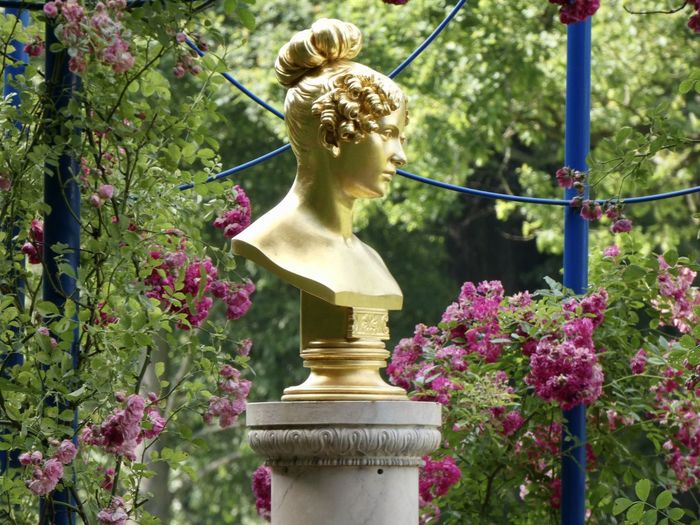 Close-up of statue against flowering plants