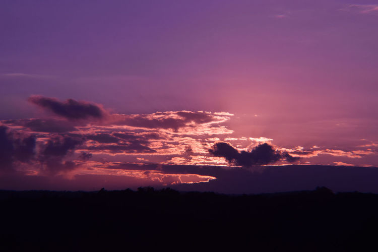 Scenic view of silhouette purple sky at sunset