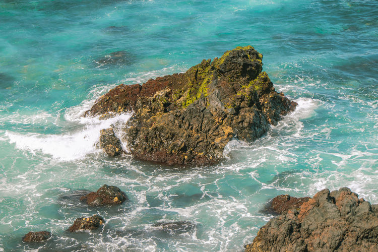 High angle view of rocks in sea