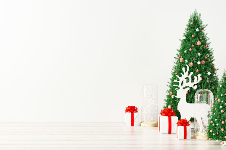 Christmas decorations on table against white background