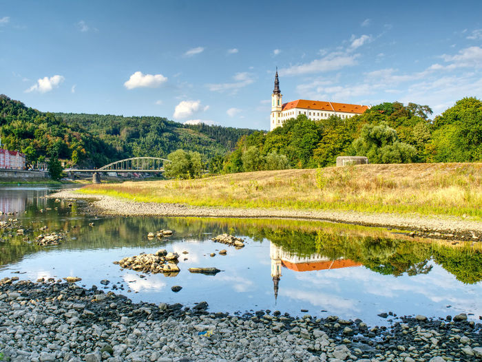 Dry riverbed of river elbe in decin, czech summer 2018. empty river bed. decin castle above bridge