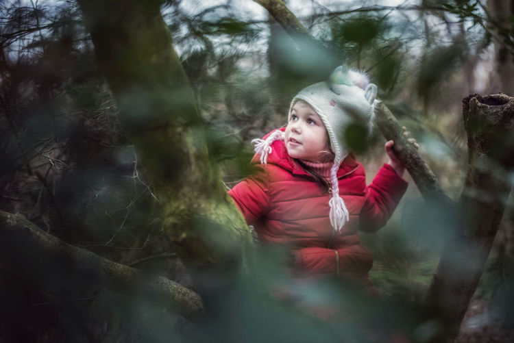 Portrait of girl looking away in forest