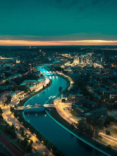 High angle view of illuminated city buildings at night