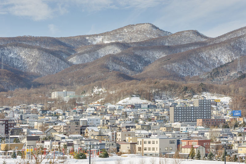 Hokkaido, japan - december 14, 2011 / cityscape of sapporo with the mountain background in winter