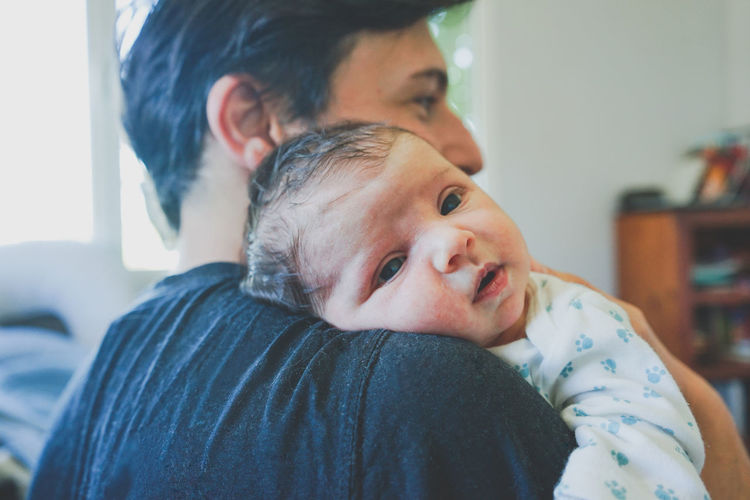 Portrait of father with baby at home