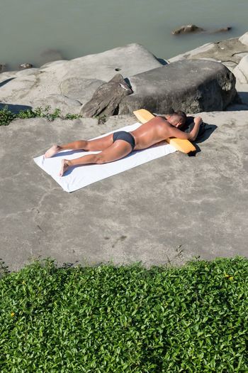 High angle view of woman lying on beach