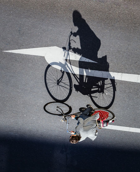 High angle view of man with bicycle on street