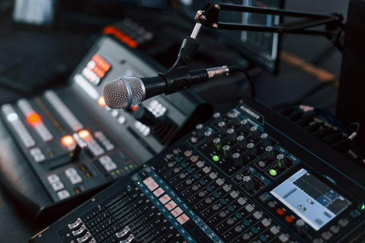 Close up view of radio mixing desk with professional sound equipment.