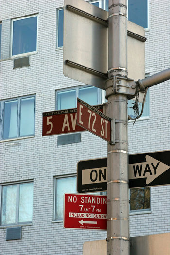 Low angle view of road sign against building