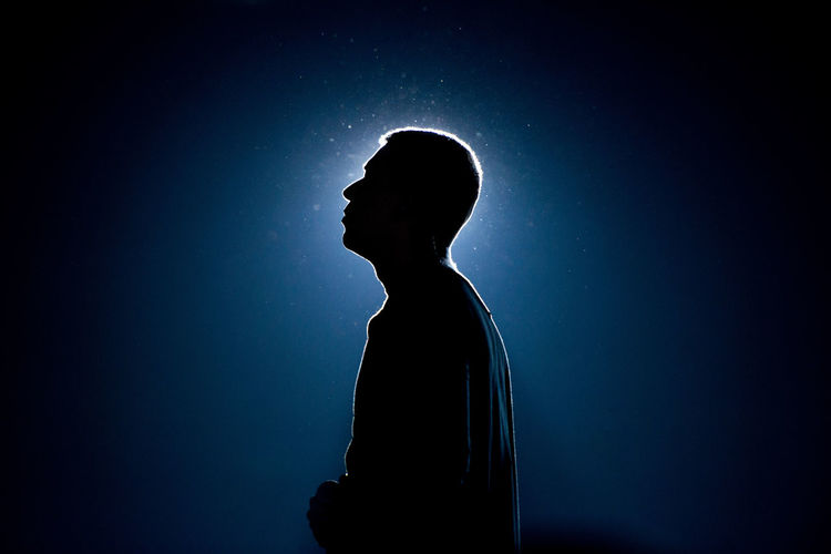 Silhouette of man against black background