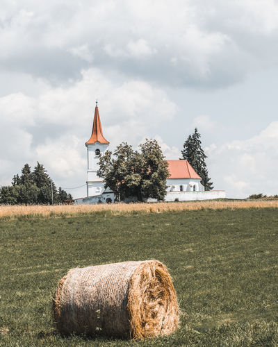 Village church with hay bale