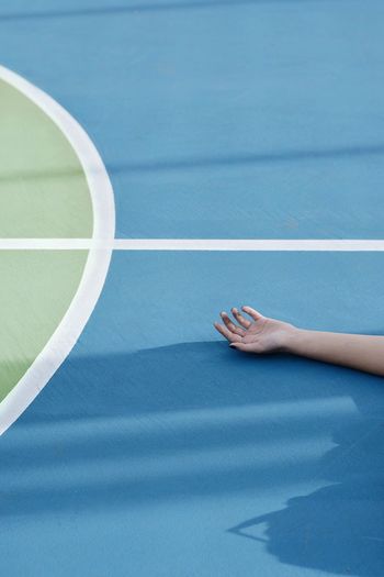 Cropped hand of woman on court