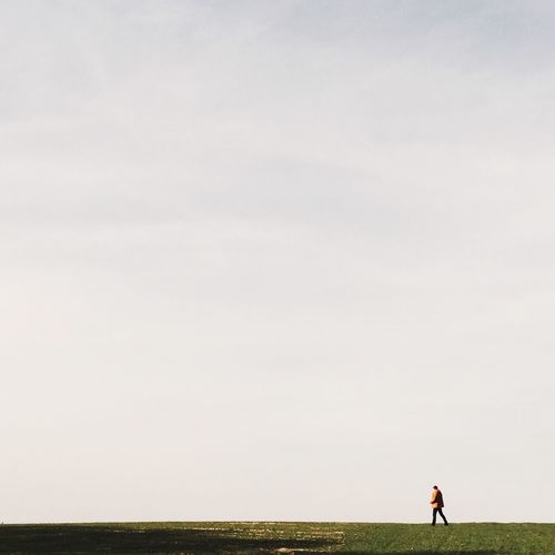 Rear view of woman standing on grassy field