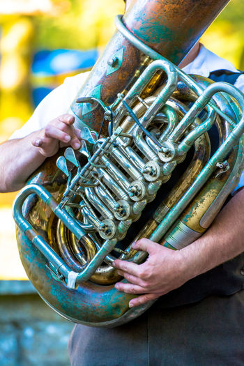 Midsection of man playing tuba at event