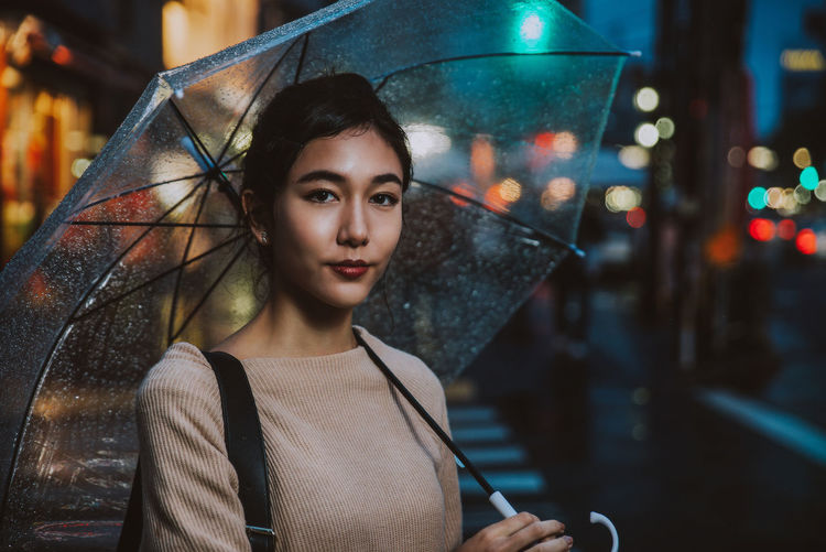 Portrait of young woman in rain