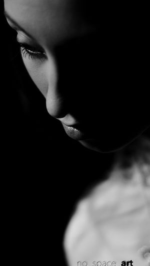 High section of young woman against black background