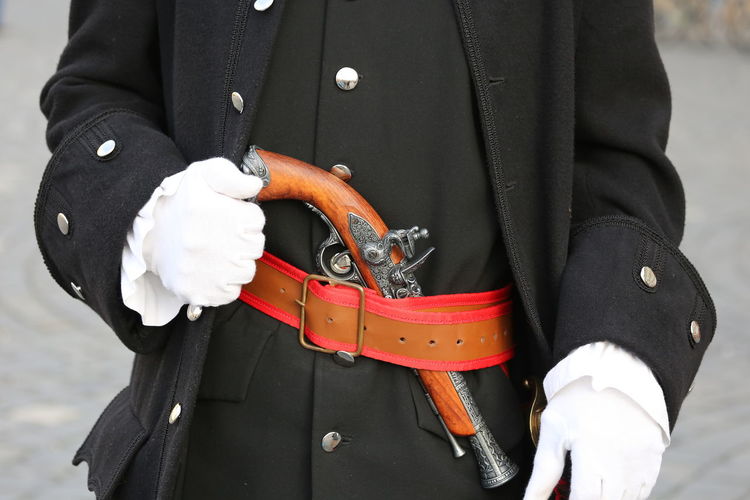 Midsection of man wearing uniform