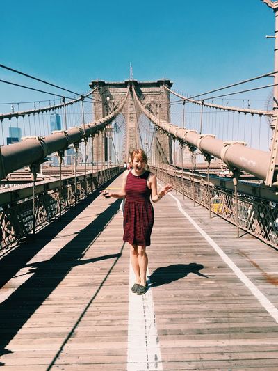 Full length of woman standing on bridge