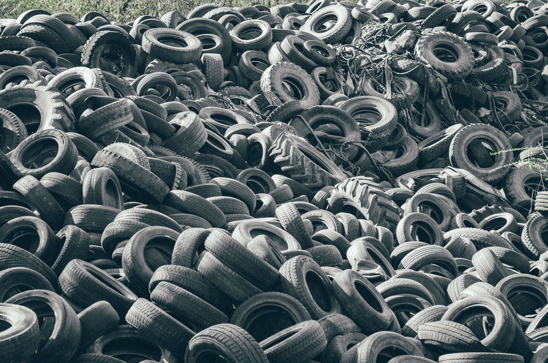 Landfill of old car tires torn spoiled abandoned.