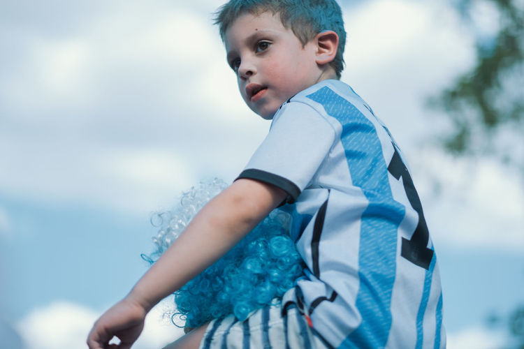 Low angle portrait of argentinian child celebrating victory on fifa world cup 2022 qatar