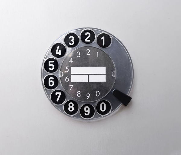 Close-up of rotary phone over white background