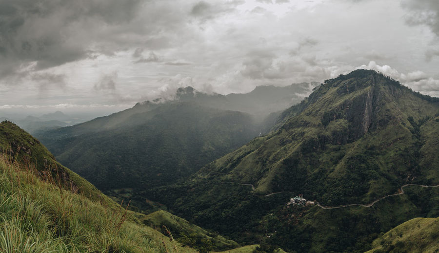 Scenic view of mountains against cloudy sky