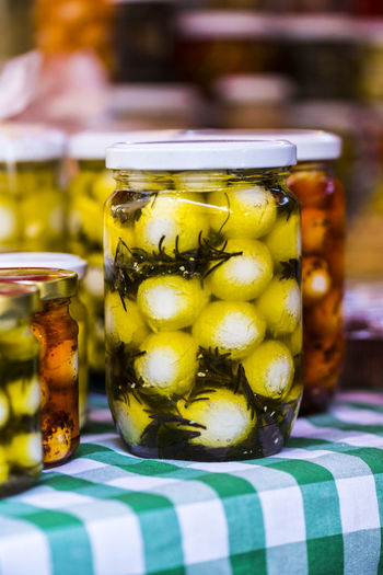 Close-up of pickled cheese in jars for sale in store