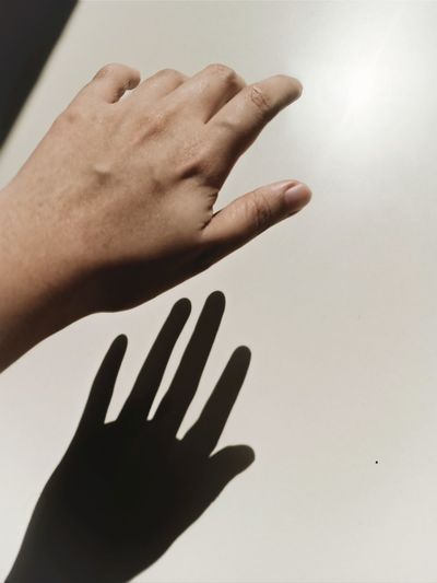 Close-up of hands against wall