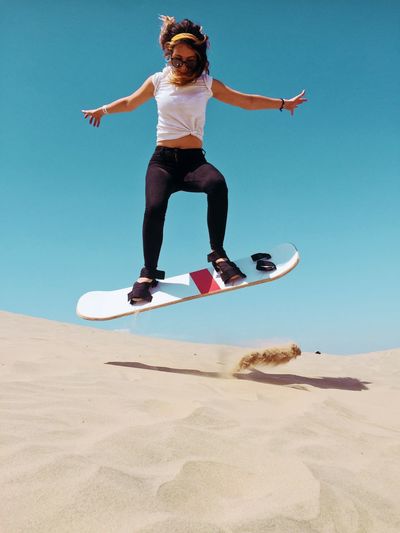 Full length of man jumping on beach