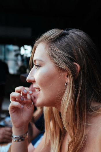 Close-up portrait of a young woman drinking ice cream